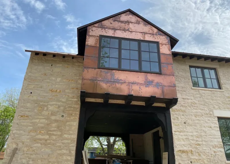 Copper metal panel facade on a stone building for Skylight Installation in Blooming Grove