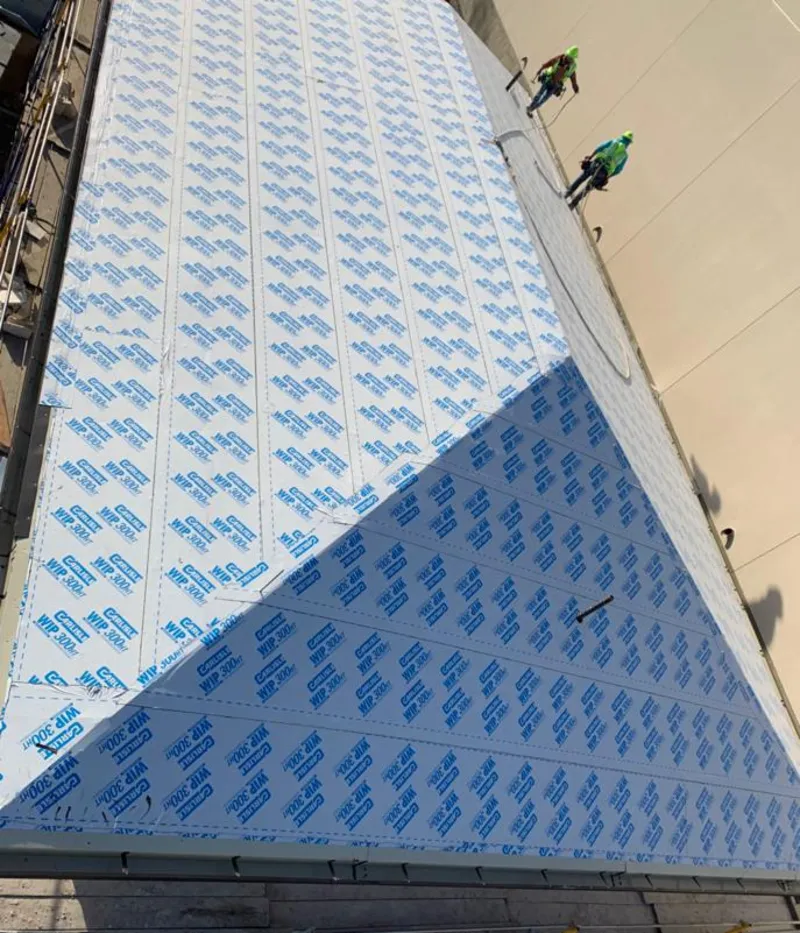 Professional roofers installing underlayment on a metal roof in Blooming Grove